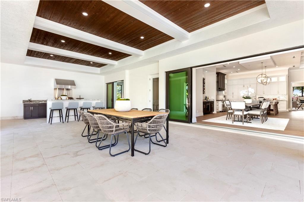 437 West Street Naples, FL 34108 - Photo 28 of 35 a dining room with furniture and a floor to ceiling window