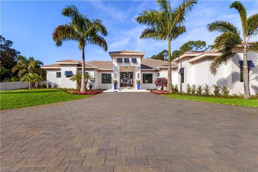 437 West Street Naples, FL 34108 - Photo 31 of 35 a front view of a building with palm trees