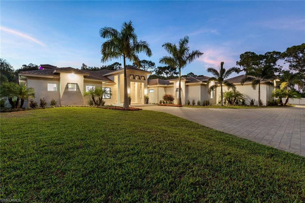 437 West Street Naples, FL 34108 - Photo 32 of 35 a front view of house with yard and green space