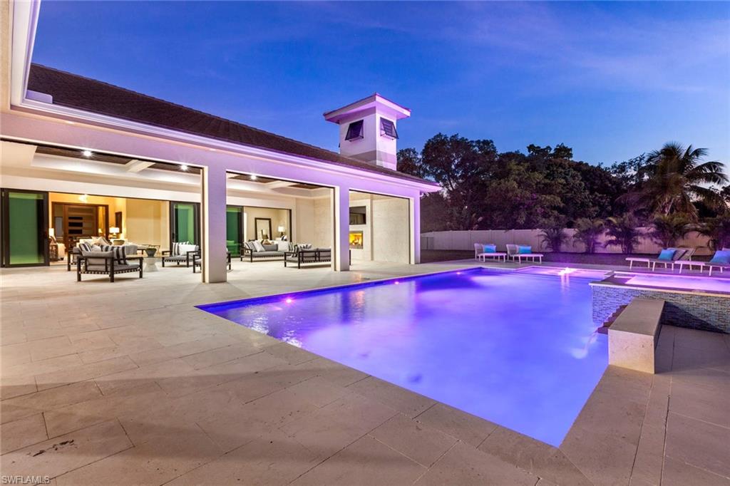 437 West Street Naples, FL 34108 - Photo 34 of 35 a view of a swimming pool with outdoor seating