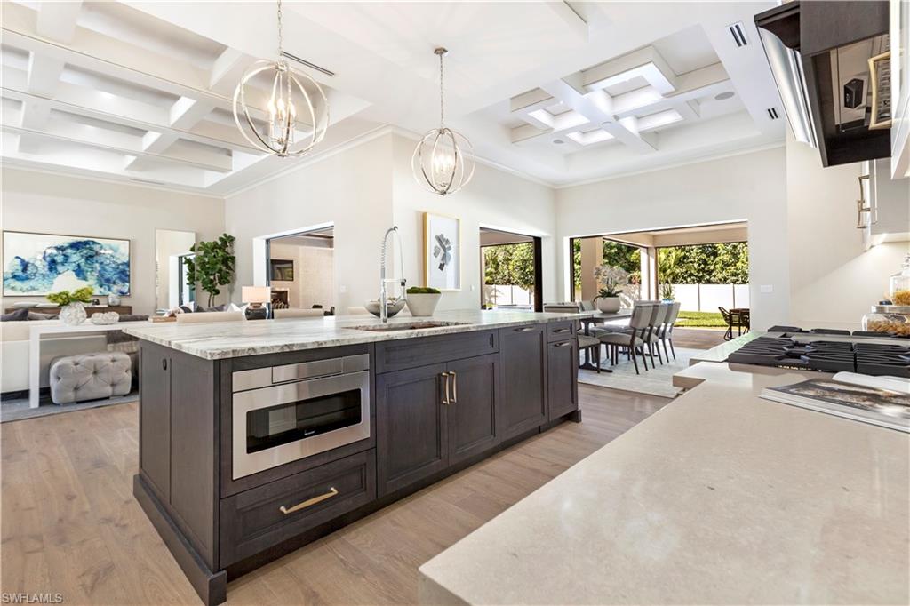 437 West Street Naples, FL 34108 - Photo 7 of 35 a kitchen with stainless steel appliances a stove oven and a chandelier