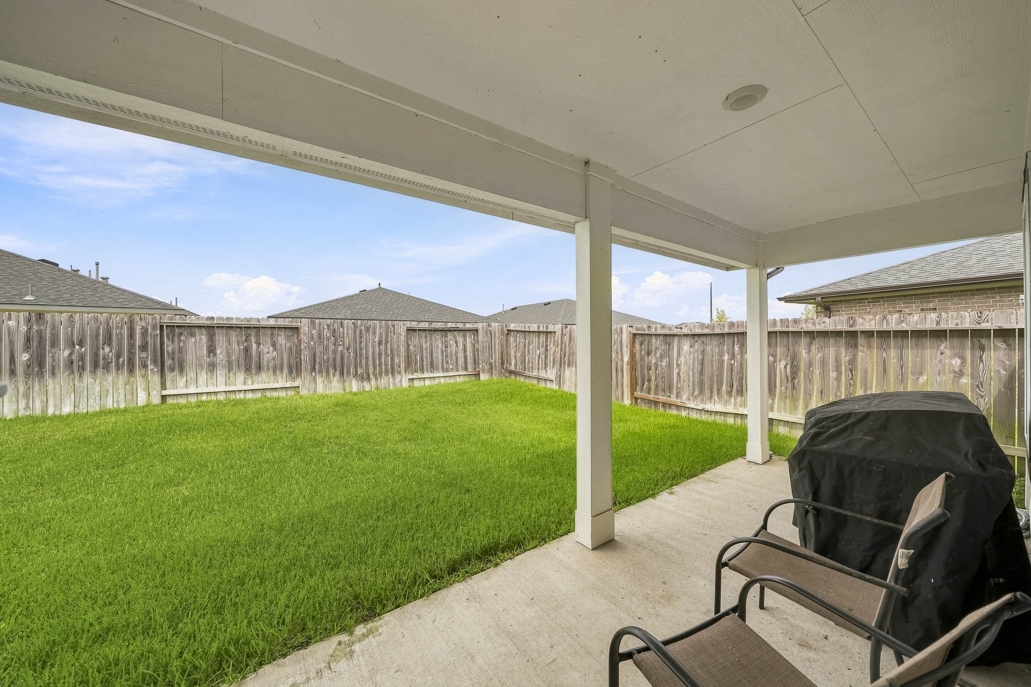 919 Tall Shire Court Rosharon, TX 77583 - Photo 17 of 19 This covered patio section provides shelter from the elements while looking out over a spacious, fully fenced lawn. The private yard offers plenty of open space and clean sightlines.