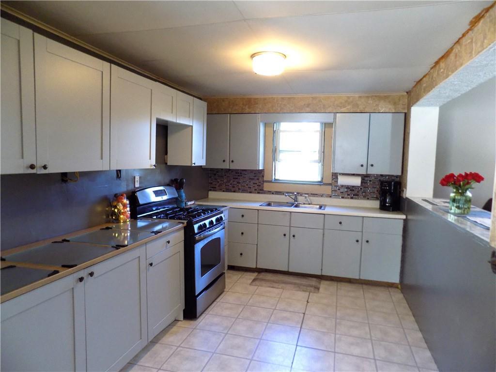 1067 Silver Lane McKees Rocks, PA 15136 - Photo 12 of 25 a kitchen with a stove sink and cabinets
