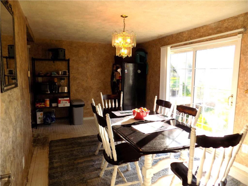 1067 Silver Lane McKees Rocks, PA 15136 - Photo 13 of 25 a view of a dining room with furniture and wooden floor