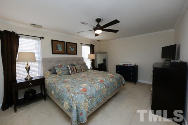 4602 Hamptonshire Drive Raleigh, NC 27613 - Photo 11 of 16 a bedroom with a bed and a flat screen tv