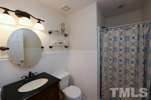 4602 Hamptonshire Drive Raleigh, NC 27613 - Photo 13 of 16 a bathroom with a sink toilet and mirror