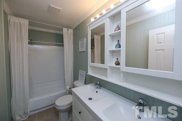 4602 Hamptonshire Drive Raleigh, NC 27613 - Photo 16 of 16 a bathroom with a bathtub shower sink mirror and toilet