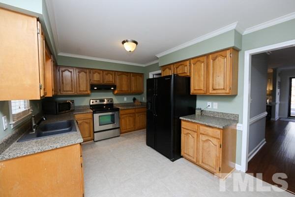 4602 Hamptonshire Drive Raleigh, NC 27613 - Photo 6 of 16 a kitchen with stainless steel appliances granite countertop a refrigerator stove top oven a sink and dishwasher