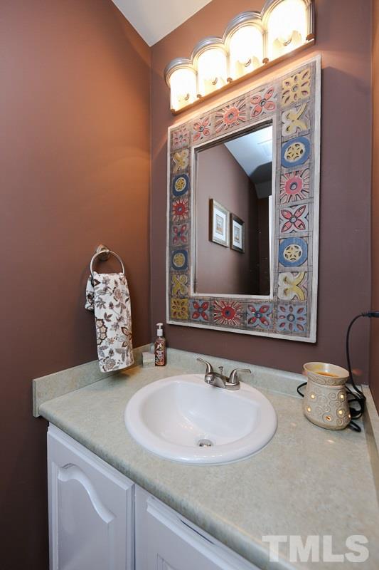 4602 Hamptonshire Drive Raleigh, NC 27613 - Photo 10 of 16 a bathroom with a double vanity sink and a mirror