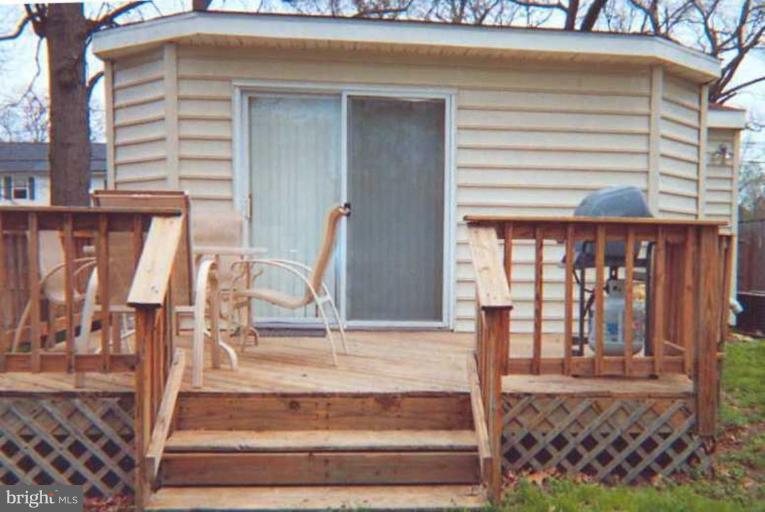 7830 East Shore Road Pasadena, MD 21122 - Photo 11 of 11 Sliders from family room lead to deck.