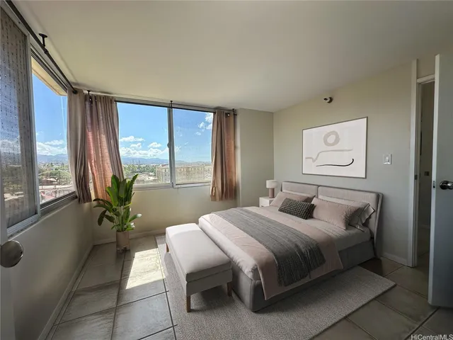 a bedroom with a bed and large windows