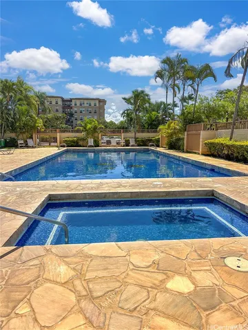a view of swimming pool with outdoor seating and plants