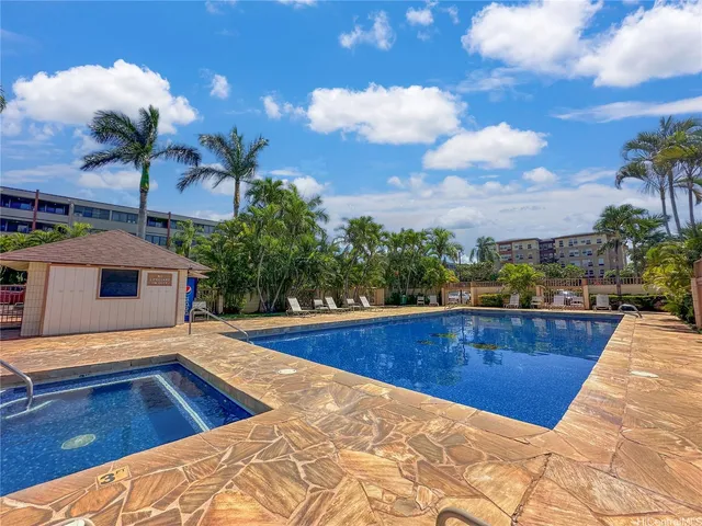 a view of an house with swimming pool and sitting area