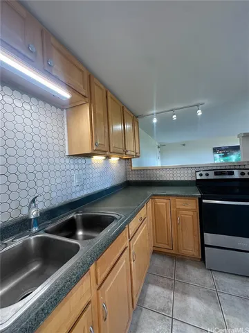 a kitchen with stainless steel appliances granite countertop a sink and a counter