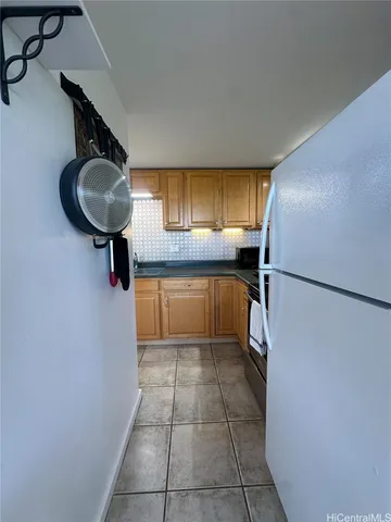 a kitchen with a refrigerator a stove and a sink