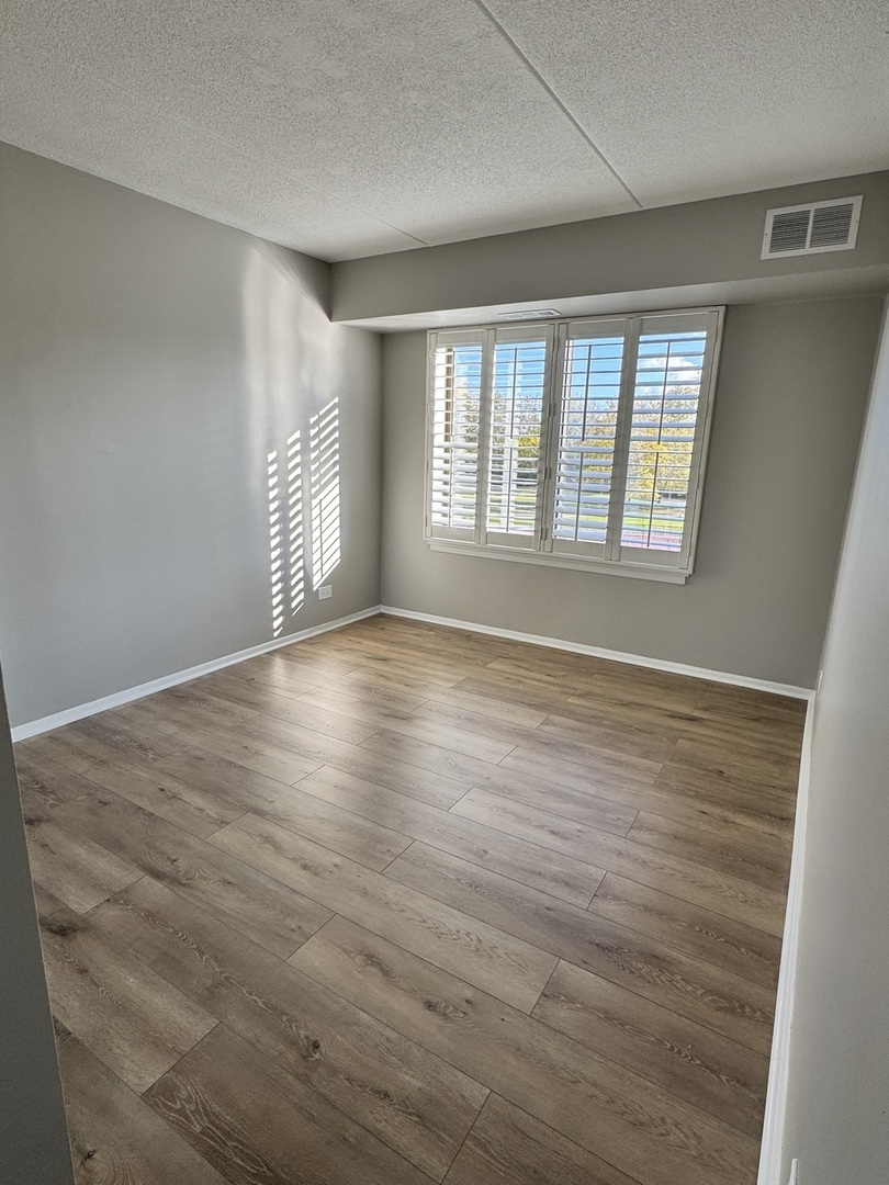 500 Park Avenue, Unit 433 Calumet City, IL 60409 - Photo 11 of 22 a view of an empty room with wooden floor and a window