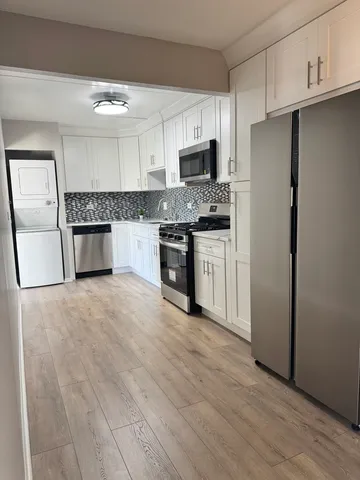 a kitchen with a refrigerator stove top oven and sink