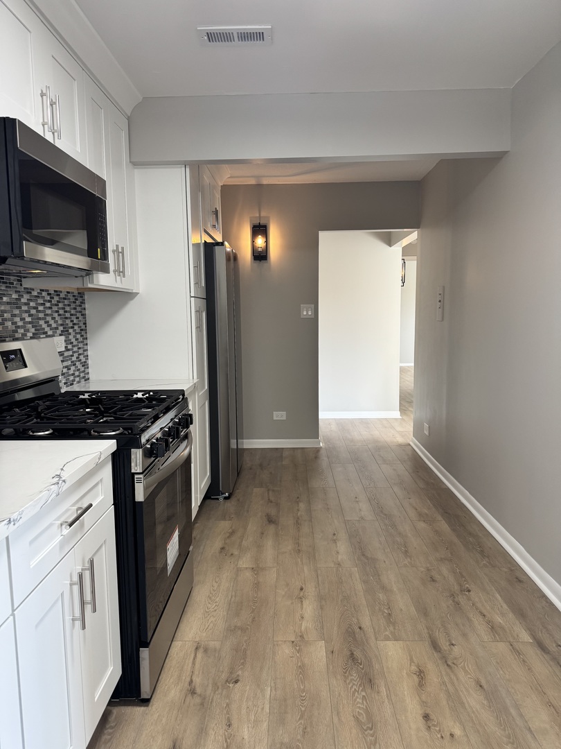 500 Park Avenue, Unit 433 Calumet City, IL 60409 - Photo 3 of 22 a kitchen with stainless steel appliances granite countertop a stove a refrigerator and a microwave