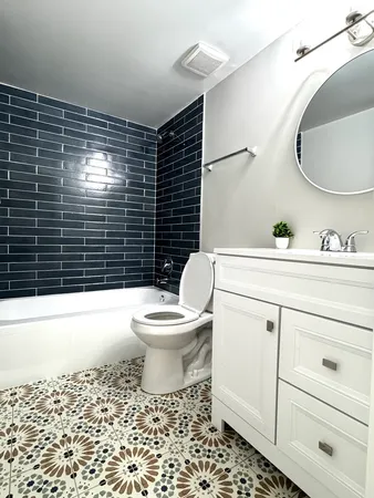 a bathroom with a toilet a sink and bathtub