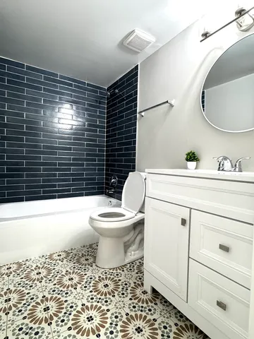 a bathroom with a toilet a sink and bathtub