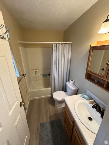 939 South Freedom Boulevard, Unit 13 Provo, UT 84601 - Photo 21 of 26 Bathroom featuring vanity, dark wood-style flooring, shower / tub combo, and a textured ceiling