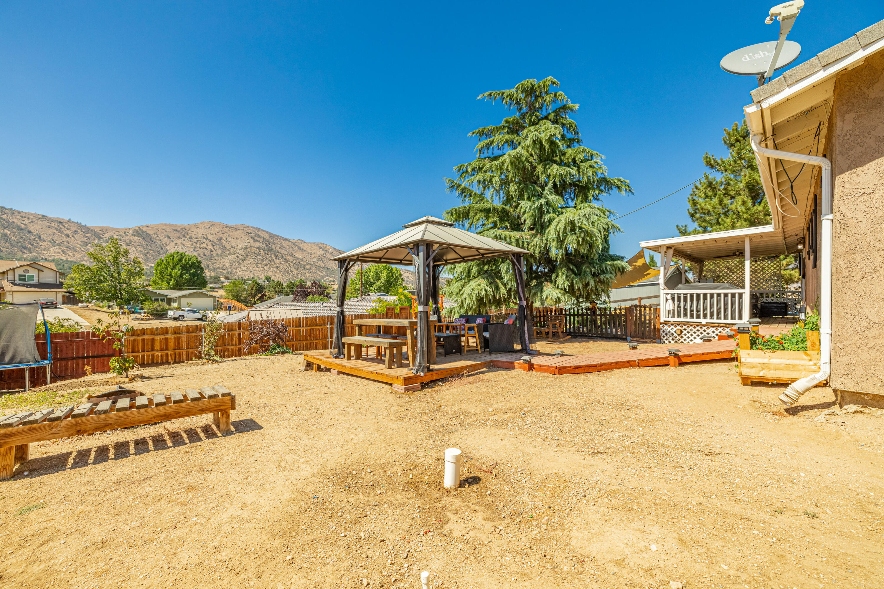 20730 Ridgecrest Drive Tehachapi, CA 93561 - Photo 22 of 26 a view of a swimming pool with a lounge chair and floor to ceiling window