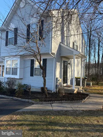 front view of a brick house with a yard