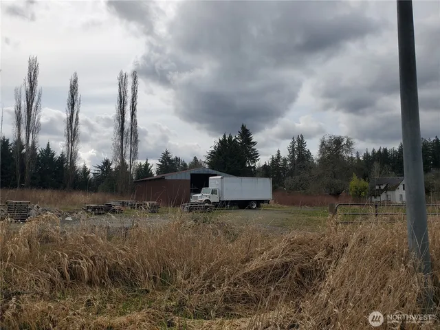 a view of a garden with a bench in the background