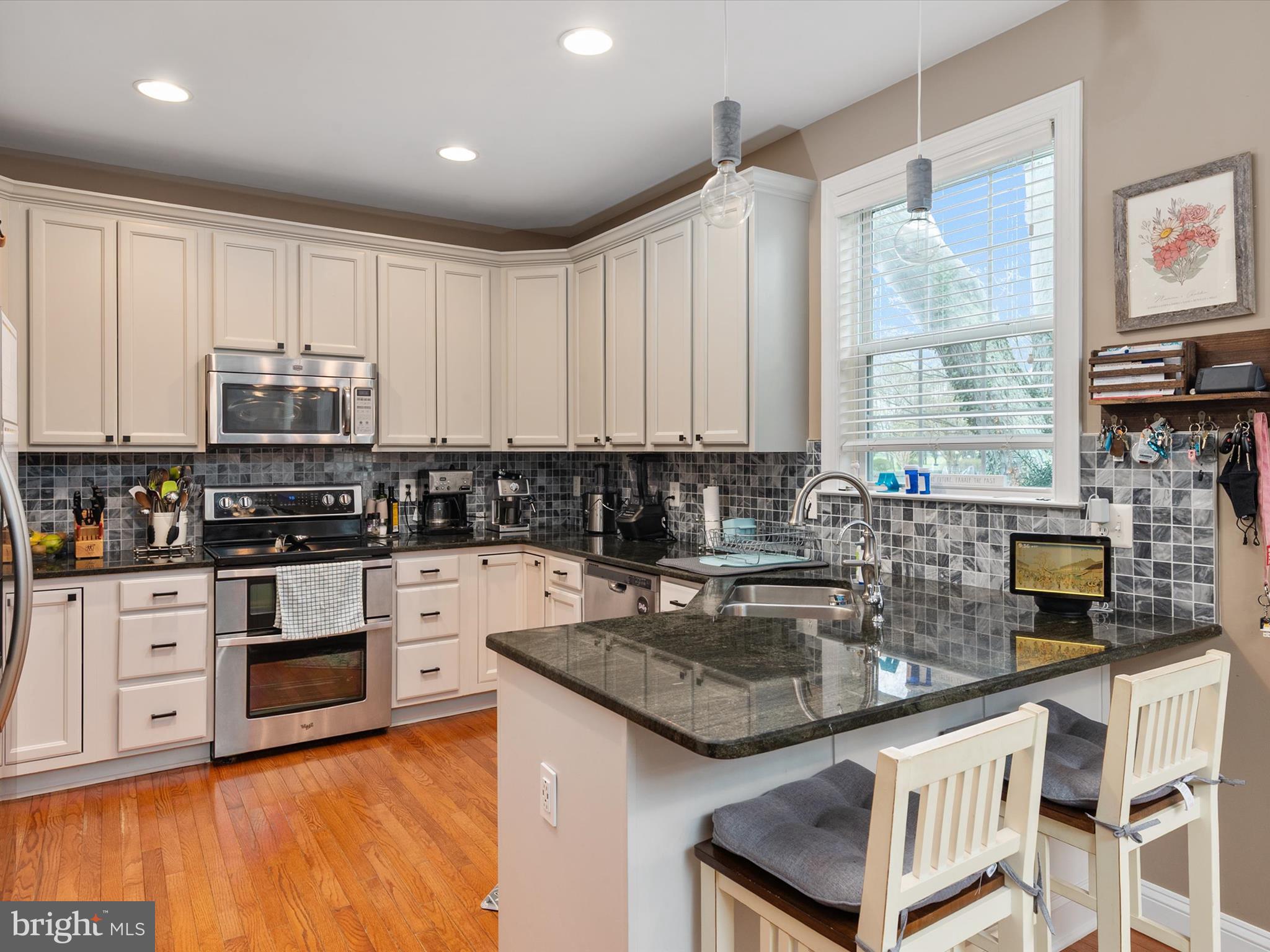 688 Red Cedar Road Annapolis, MD 21409 - Photo 12 of 54 a kitchen with stainless steel appliances granite countertop a stove a sink and white cabinets