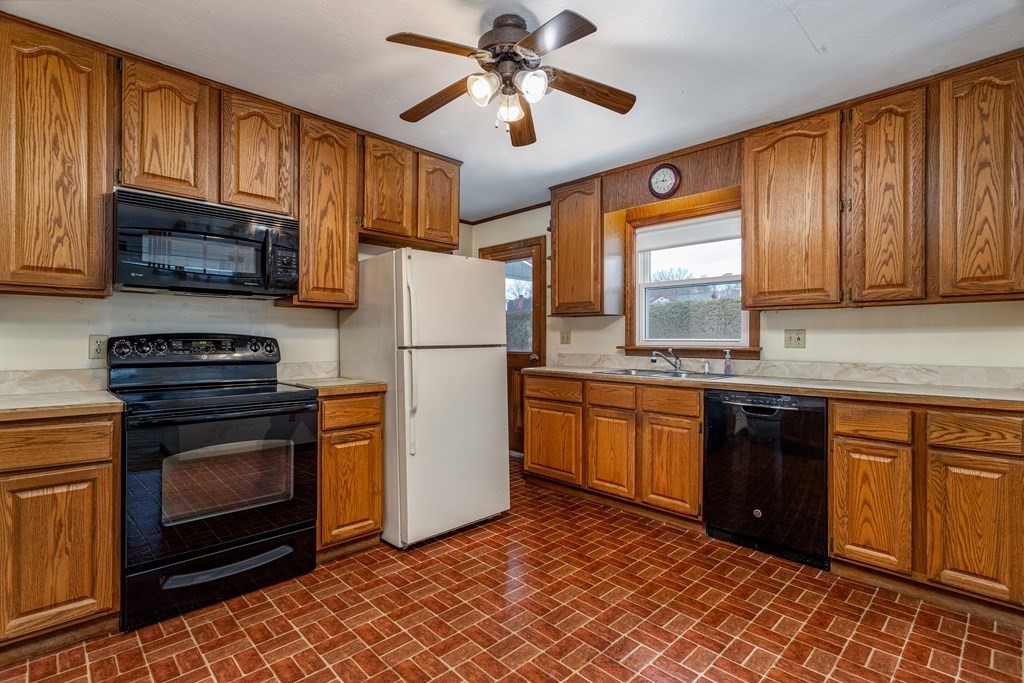 18 Page Street Shirley, MA 01464 - Photo 12 of 41 a kitchen with granite countertop a refrigerator stove top oven a sink and dishwasher