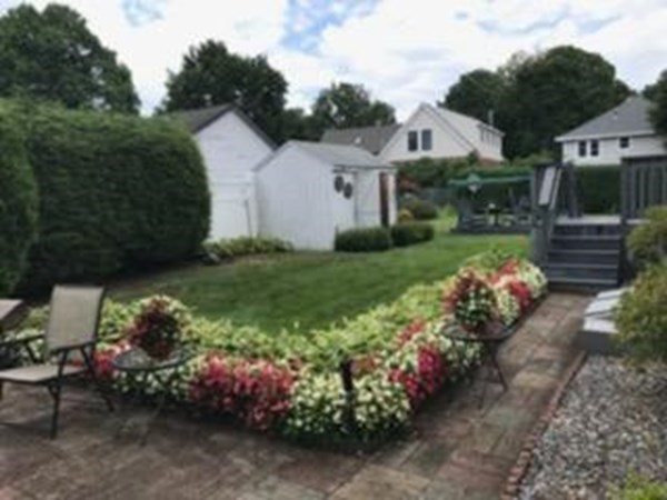 18 Page Street Shirley, MA 01464 - Photo 37 of 41 a front view of a house with a yard and a garden