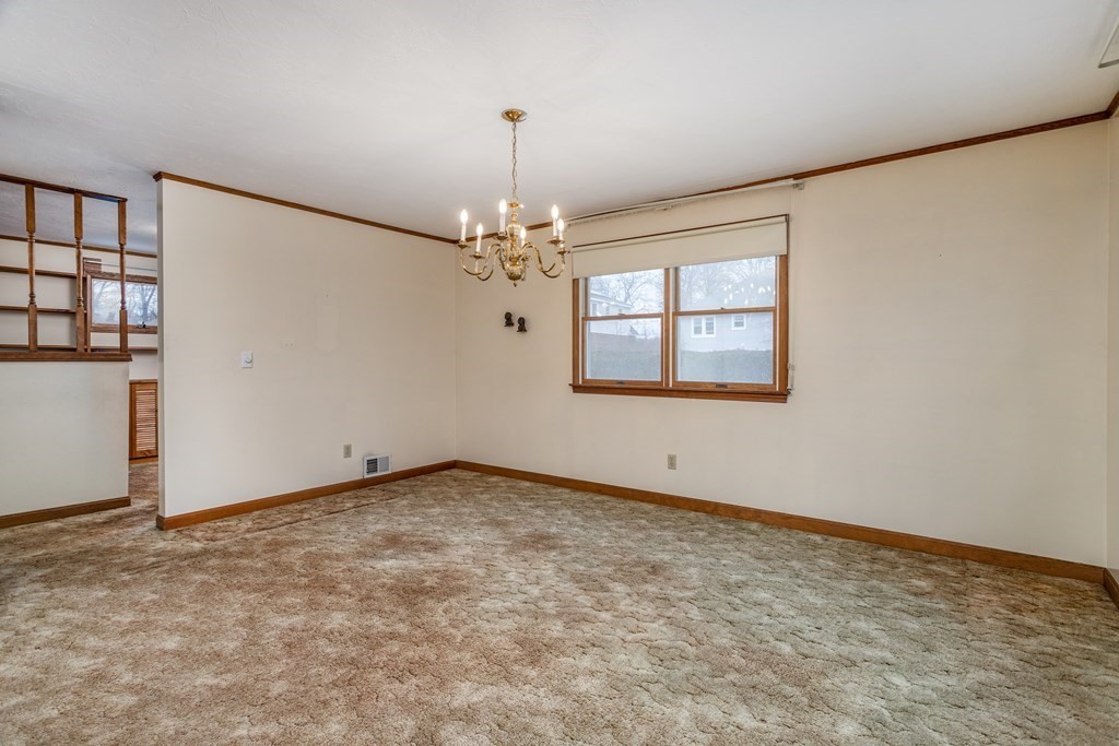 18 Page Street Shirley, MA 01464 - Photo 6 of 41 an empty room with chandelier fan and windows