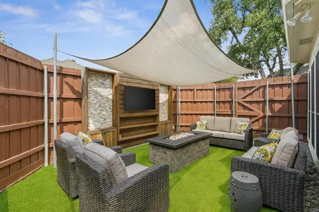 a outdoor living space with furniture and a flat screen tv
