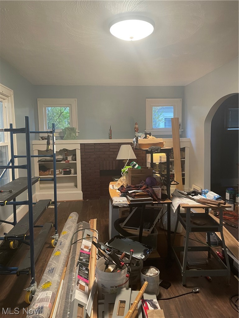Living Room with Decorative Fireplace and Built in shelfs