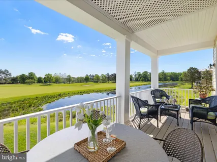 a view of a chair and tables in the balcony