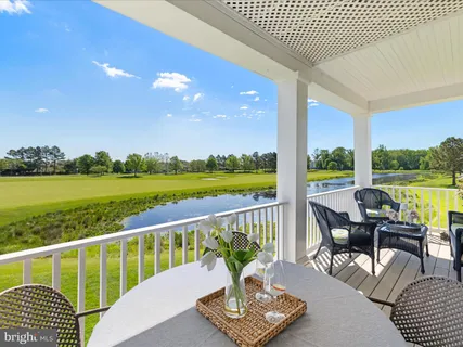 a view of a chairs and table in the balcony