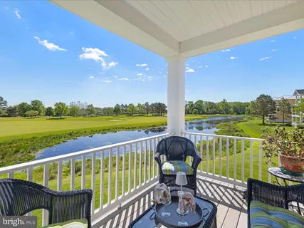 a view of a chairs and table in the balcony