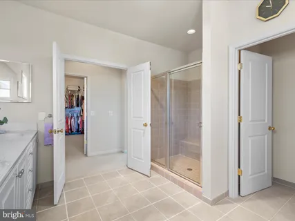 a bedroom with a bed and a lamp on dresser