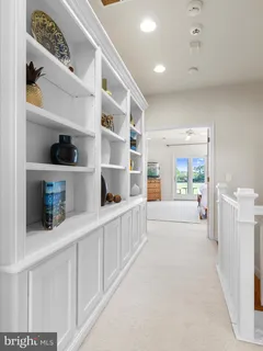 a spacious bedroom with two beds and glass door