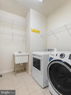 a bedroom with two beds and painting on the wall