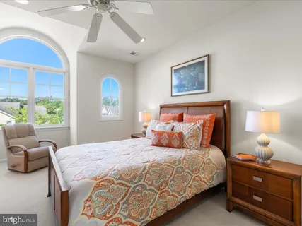 a spacious bedroom with a bed and a dresser