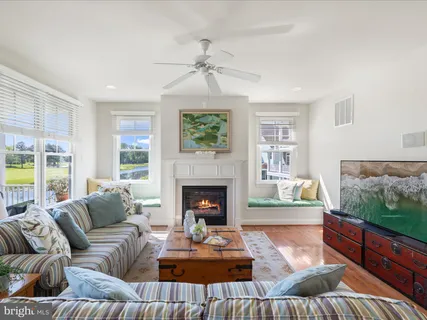 a living room with furniture fireplace and window