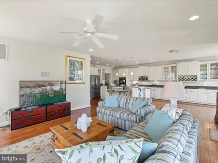 a living room with furniture with kitchen view