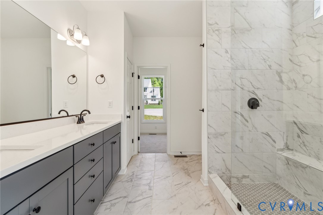 3953 Robins Ridge Drive Moseley, VA 23120 - Photo 17 of 25 a spacious bathroom with a granite countertop sink a mirror and shower