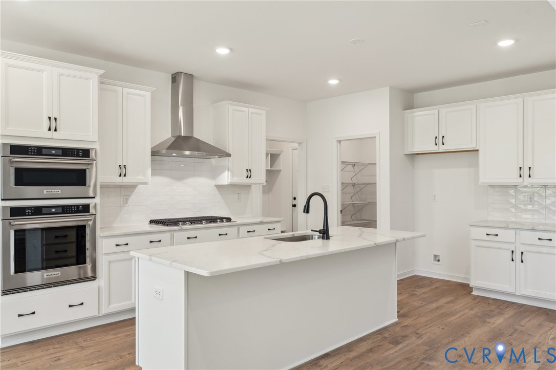 3953 Robins Ridge Drive Moseley, VA 23120 - Photo 2 of 25 a kitchen with kitchen island a stove a sink and a refrigerator