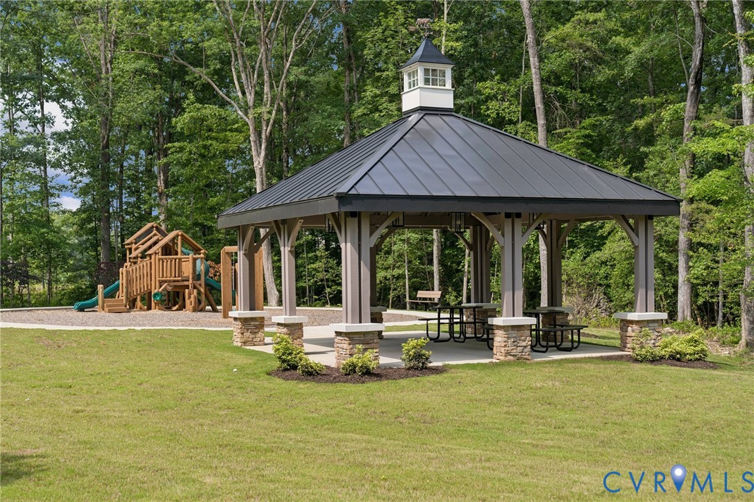 3953 Robins Ridge Drive Moseley, VA 23120 - Photo 22 of 25 a backyard of a house with yard table and chairs