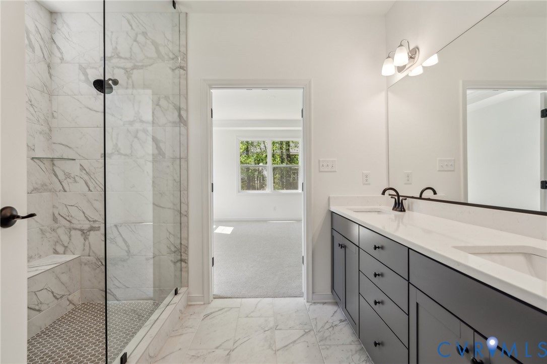 3953 Robins Ridge Drive Moseley, VA 23120 - Photo 4 of 25 a bathroom with a double vanity sink a large mirror a shower and a bathtub
