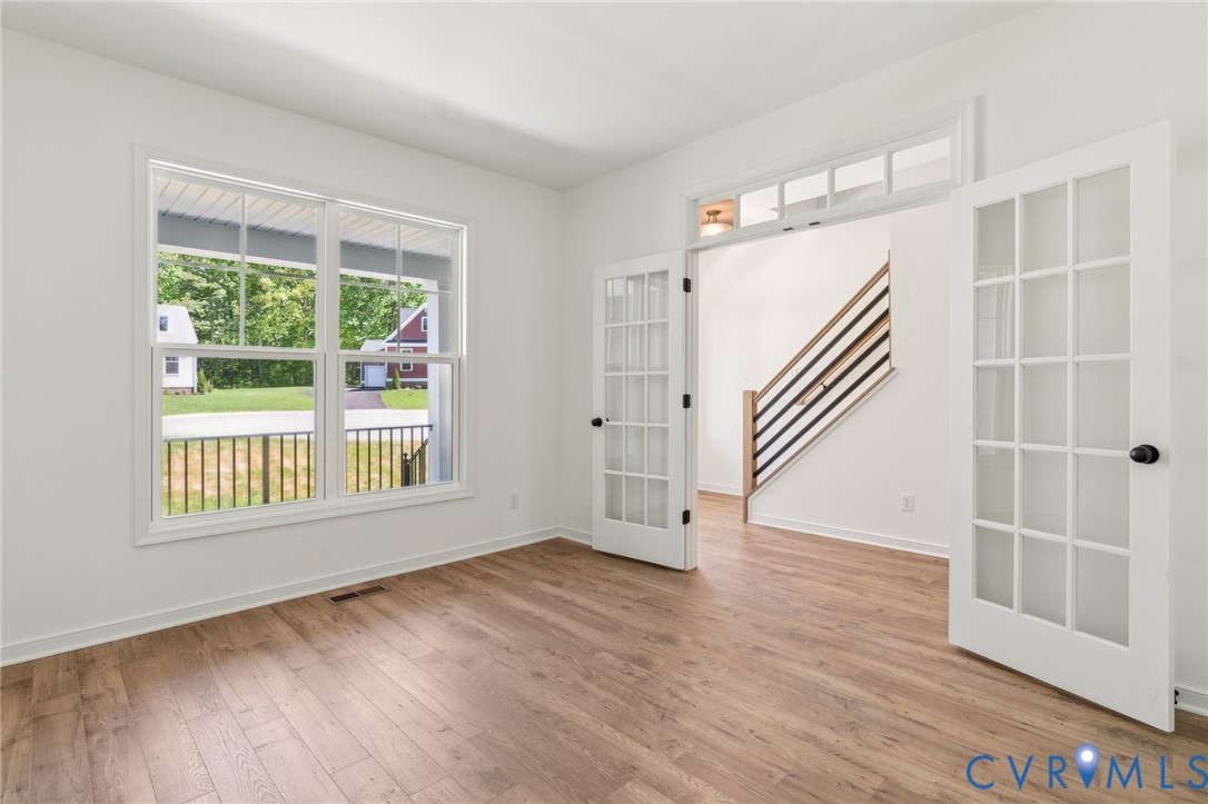3953 Robins Ridge Drive Moseley, VA 23120 - Photo 6 of 25 an empty room with wooden floor and windows