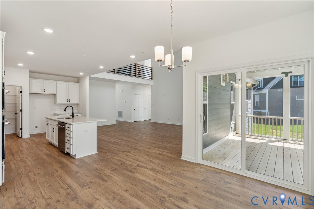 3953 Robins Ridge Drive Moseley, VA 23120 - Photo 8 of 25 a view of a kitchen with wooden floor and a window