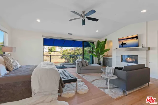 a living room with furniture a fireplace and a flat screen tv